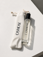 A 15ml glass perfume spray bottle labeled ALLURE VIVE, an extrait de parfum, sitting next to its matching drawstring fabric pouch.